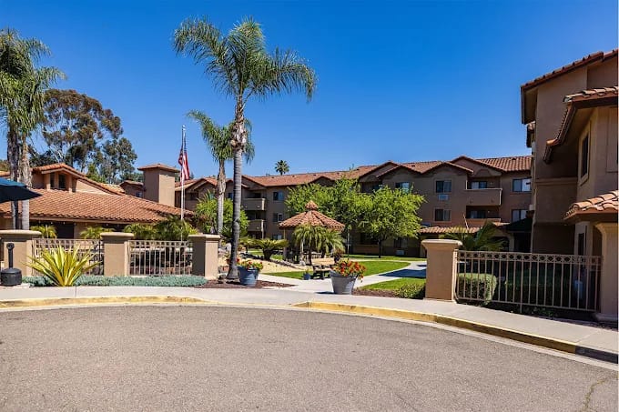 Front of Senior Housing Community with palm tree and large building
